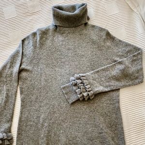 Sofiacashmere ruffle cashmere turtleneck sweater.